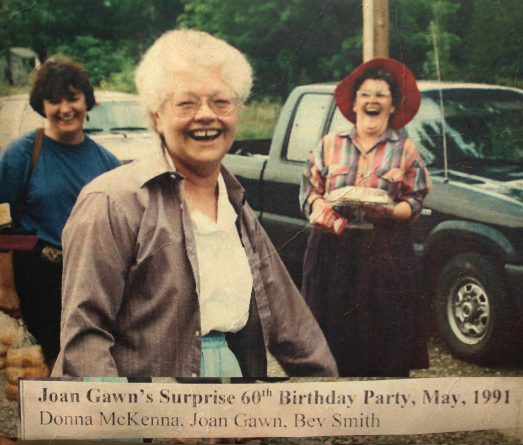 An old photo from 1991 of three women, Donna McKenna, Joan Gawn and Bev Smith. The women are laughing. It's a surprise 60th birthday party for Joan.